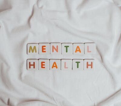 Close-up of 'Mental Health' text on cloth, symbolizing calmness and self-care.